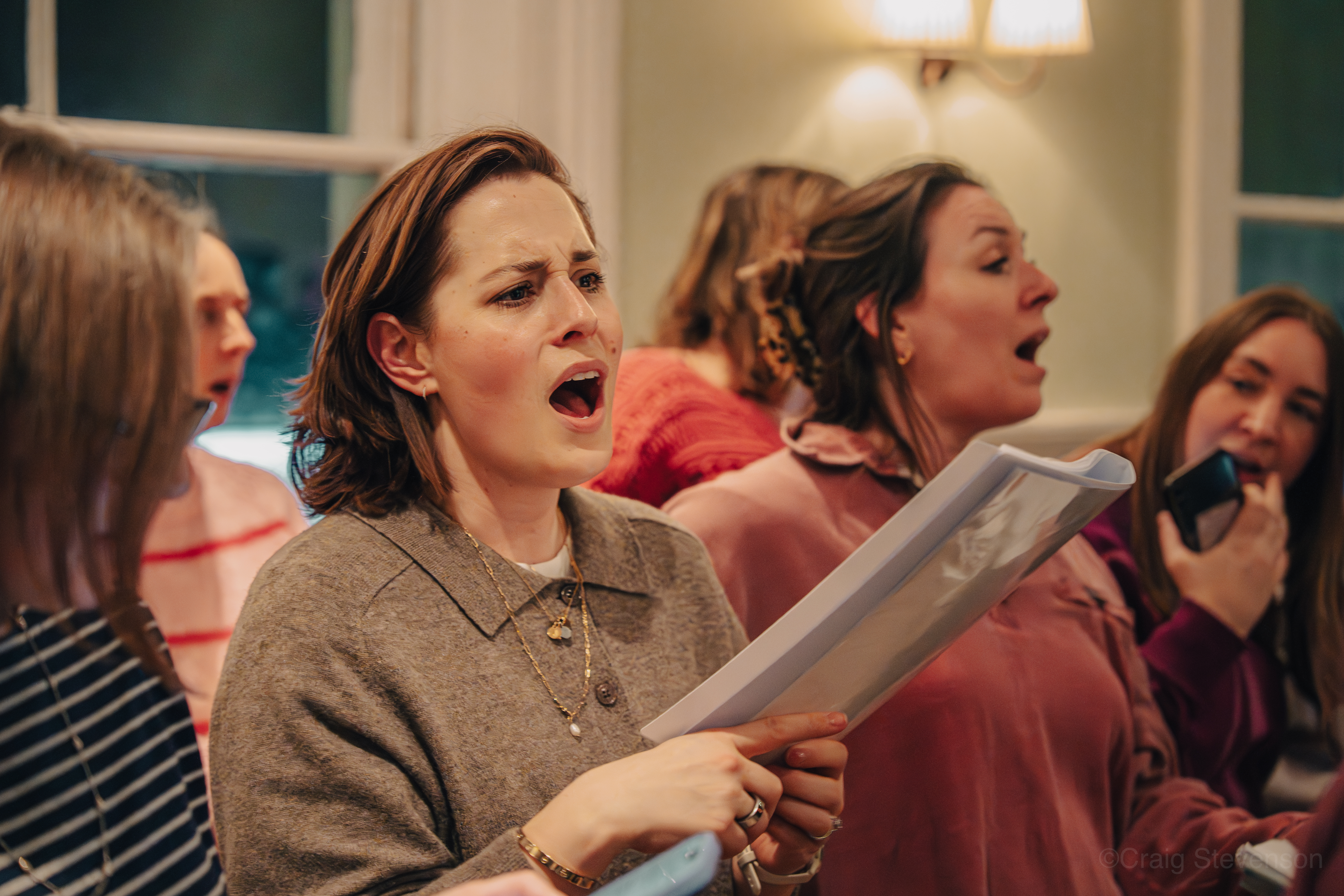 SLYMI singers rehearsing with microphones